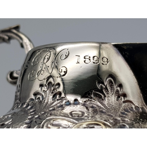 108 - A SMALL SOLID SILVER JUG WITH THE INSCRIPTION 