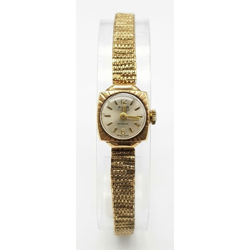 247 - A vintage, 9 K yellow gold AVIA INCABLOC ladies watch. 14  mm case, champagne coloured dial with gol... 