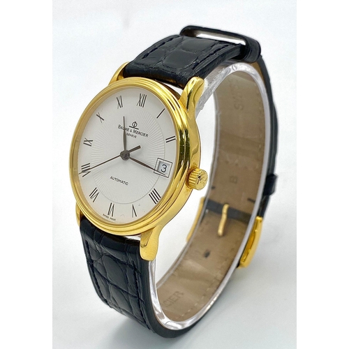 39 - A Baume and Mercier 18K Gold Cased Automatic Gents Watch. Model - MV045075. Black leather strap. 18k... 