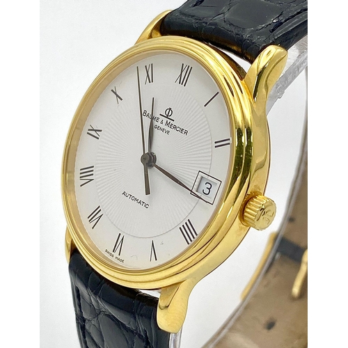 39 - A Baume and Mercier 18K Gold Cased Automatic Gents Watch. Model - MV045075. Black leather strap. 18k... 