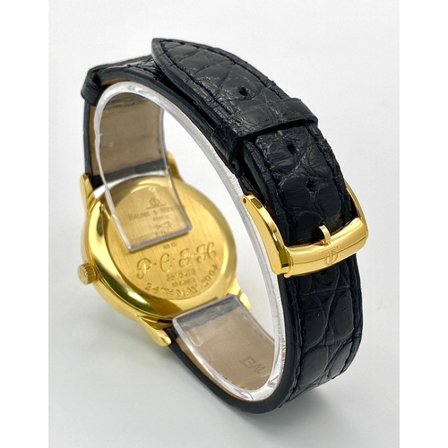 39 - A Baume and Mercier 18K Gold Cased Automatic Gents Watch. Model - MV045075. Black leather strap. 18k... 