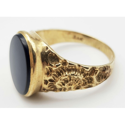 502 - A 9 k yellow gold fancy cygnet ring with an oval cut black onyx, size: W, weight: 5.4 g.