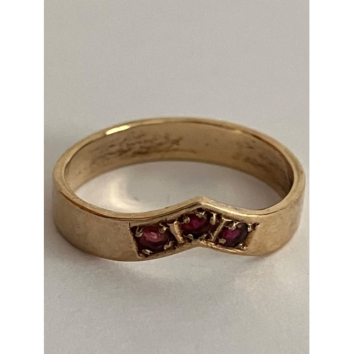 567 - 9 carat GOLD and RUBY RING. Having three round cut RUBIES set in a GOLD CHEVRON RING. Full UK hallma... 