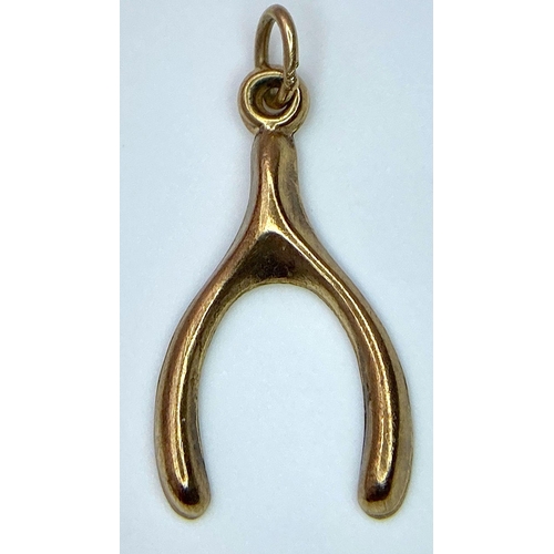 822 - A 9K YELLOW GOLD WISHBONE CHARM. TOTAL WEIGHT 0.4G