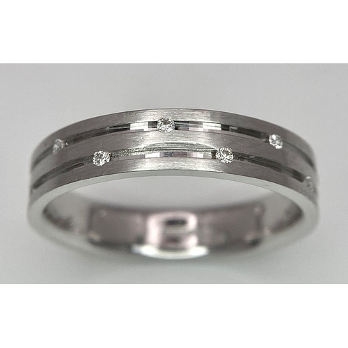 138 - An 18K White Gold Two-Row Diamond Eternity Ring. Size O. 4.9g total weight.