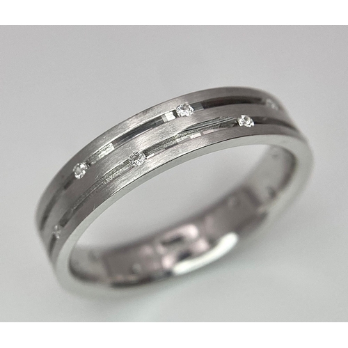 138 - An 18K White Gold Two-Row Diamond Eternity Ring. Size O. 4.9g total weight.