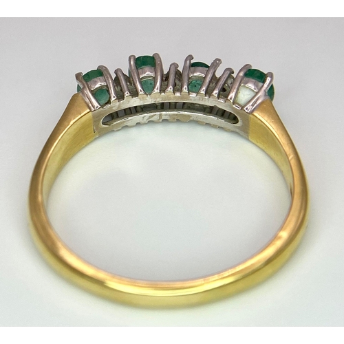 157 - An 18 K yellow gold ring with a band of alternating diamonds and emeralds, size: R, weight: 3.9 g.