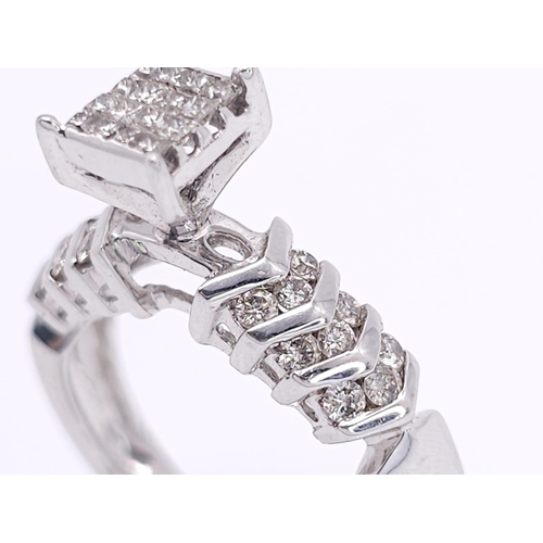 327 - A 14K White Gold Diamond Ring. Miniature square cut diamonds in a raised setting with round cut diam... 