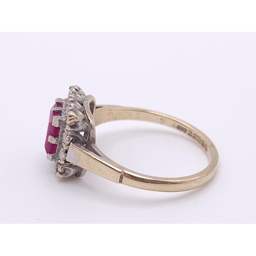 387 - A vintage 9 K yellow gold ring with a square emerald cut ruby surrounded by a halo of white sapphire... 