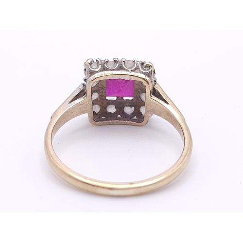 387 - A vintage 9 K yellow gold ring with a square emerald cut ruby surrounded by a halo of white sapphire... 