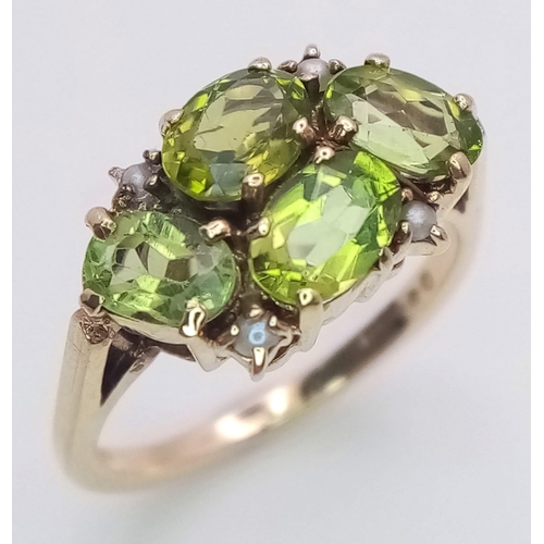 505 - A vintage 9 K yellow gold ring with four oval cut peridots and seed pearls, size: K1/2, weight: 3 g.