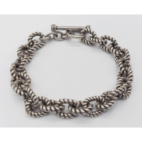 547 - A sterling silver bracelet, with rope shaped links and T bar clasp, weight: 32.1 g.