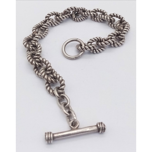 547 - A sterling silver bracelet, with rope shaped links and T bar clasp, weight: 32.1 g.