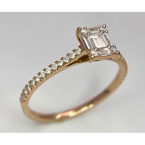 178 - An 18 K rose gold ring with a square emerald cut diamond and more round cut diamonds on the shoulder... 