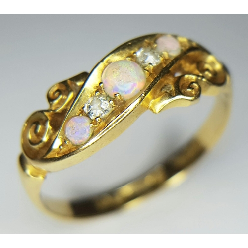 192 - An antique, 18 K yellow gold ring with two round cut diamonds between three wonderful round opal cab... 