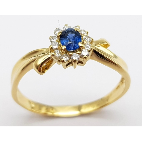 463 - An 18 K yellow gold ring with an oval cut  blue sapphire surrounded by a halo of diamonds. Size: L, ... 