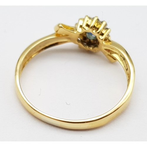 463 - An 18 K yellow gold ring with an oval cut  blue sapphire surrounded by a halo of diamonds. Size: L, ... 