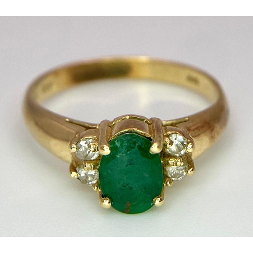 207 - A 14K Yellow Gold Emerald and Diamond Ring. Central oval cut emerald with two round cut diamonds eit... 