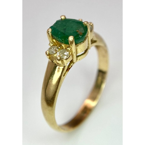 207 - A 14K Yellow Gold Emerald and Diamond Ring. Central oval cut emerald with two round cut diamonds eit... 