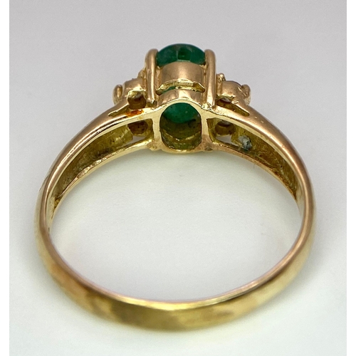 207 - A 14K Yellow Gold Emerald and Diamond Ring. Central oval cut emerald with two round cut diamonds eit... 