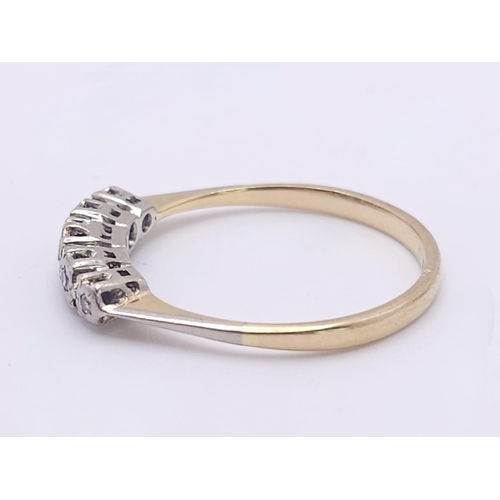 267 - An 18 K yellow gold ring with a band of five diamonds, size: S, weight: 2.4 g.