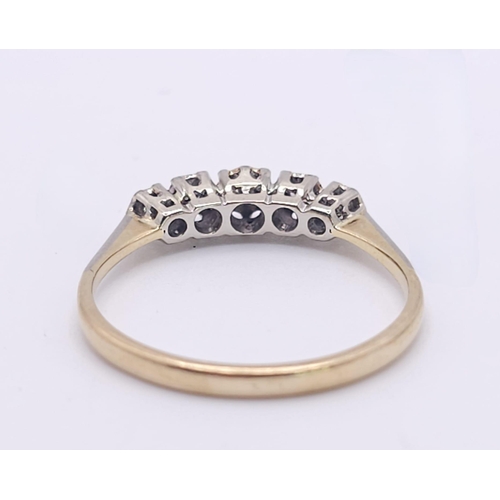 267 - An 18 K yellow gold ring with a band of five diamonds, size: S, weight: 2.4 g.