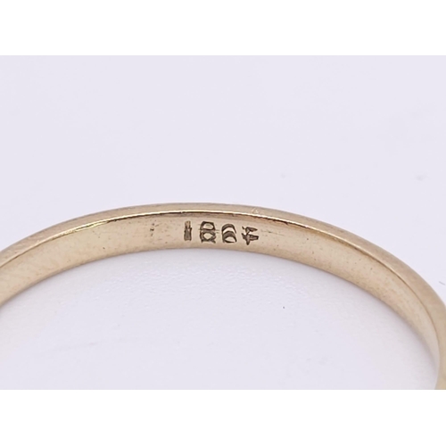 267 - An 18 K yellow gold ring with a band of five diamonds, size: S, weight: 2.4 g.