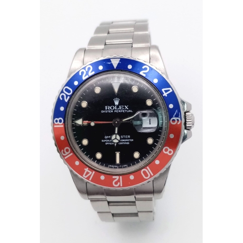 11 - A Rolex GMT Master 16750 Automatic Gents Watch. Stainless steel bracelet and case - 40mm. 'Pepsi bez... 