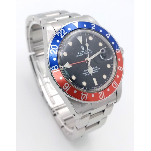 11 - A Rolex GMT Master 16750 Automatic Gents Watch. Stainless steel bracelet and case - 40mm. 'Pepsi bez... 