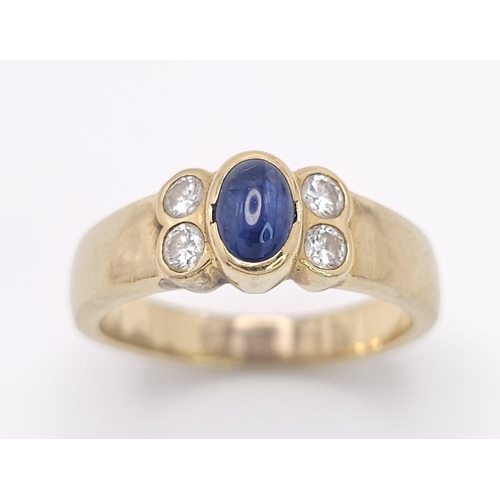 242 - An 18K Yellow Gold (tested) Sapphire and Diamond Ring. Central oval sapphire with two bright diamond... 