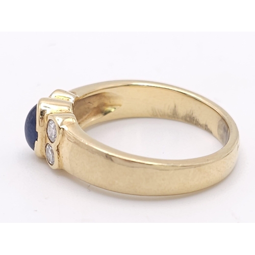 242 - An 18K Yellow Gold (tested) Sapphire and Diamond Ring. Central oval sapphire with two bright diamond... 