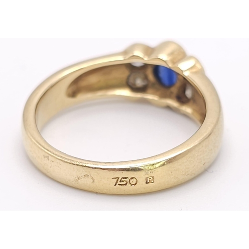 242 - An 18K Yellow Gold (tested) Sapphire and Diamond Ring. Central oval sapphire with two bright diamond... 