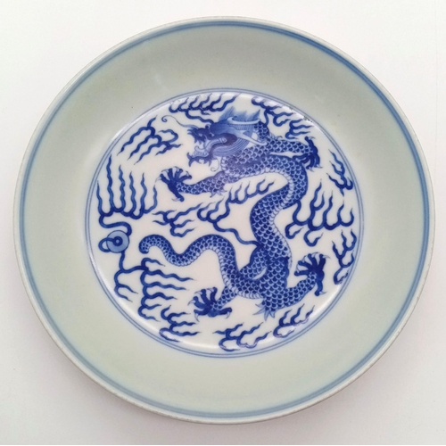 1794 - A GUANGXU ERA CHINESE DISH WITH PAINTING OF A 5 CLAWED DRAGON AND NUMBERED ON THE BOTTOM .   17cms D... 