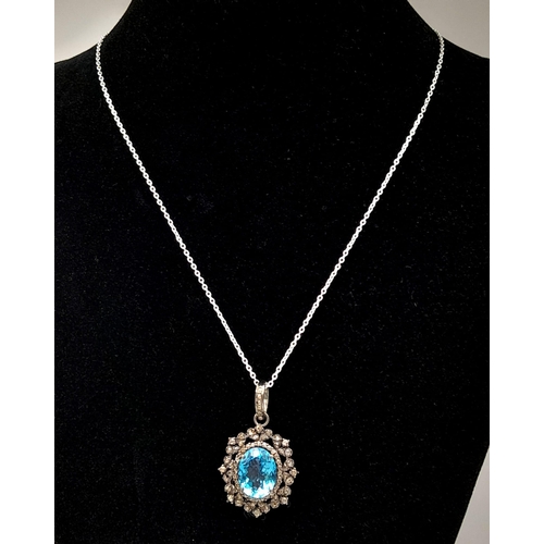 1795 - A Blue Topaz Pendant with Diamond Surround on 925 Silver and Silver Chain. 7.45ct topaz, 1.25ctw dia... 