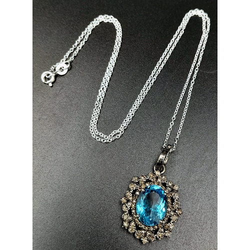 1795 - A Blue Topaz Pendant with Diamond Surround on 925 Silver and Silver Chain. 7.45ct topaz, 1.25ctw dia... 