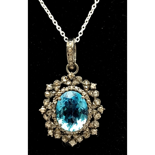 1795 - A Blue Topaz Pendant with Diamond Surround on 925 Silver and Silver Chain. 7.45ct topaz, 1.25ctw dia... 