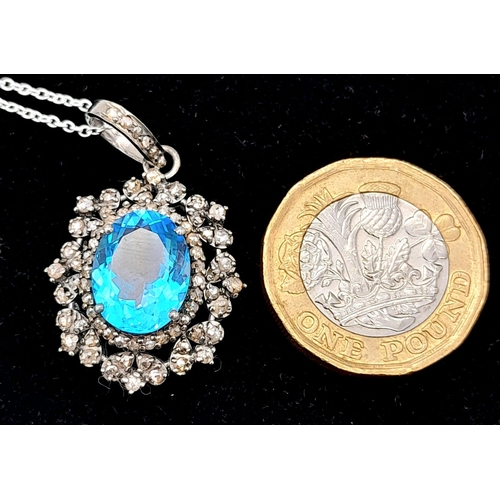 1795 - A Blue Topaz Pendant with Diamond Surround on 925 Silver and Silver Chain. 7.45ct topaz, 1.25ctw dia... 