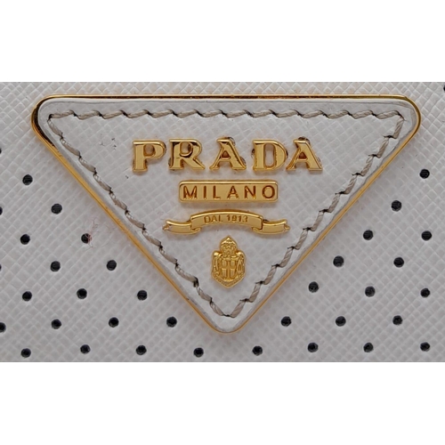 179 - A Prada beige/white perforated leather Bauletto satchel. Gold tone hardware, feet to base, no should... 