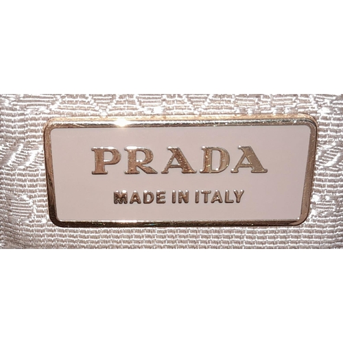 179 - A Prada beige/white perforated leather Bauletto satchel. Gold tone hardware, feet to base, no should... 