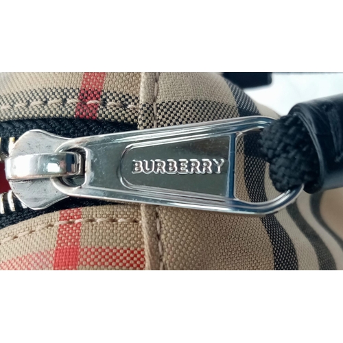 186 - A Burberry canvas bum bag (fanny pack), Silver top zip plus additional zipped pouch to front, adjust... 