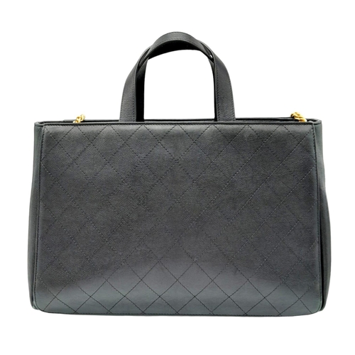 22 - A Chanel black quilted caviar leather straight line tote bag. Silver and gold tone hardware, studded... 