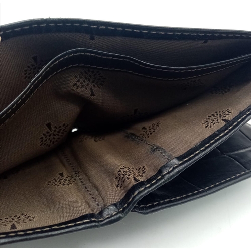 452 - A black leather Mulberry wallet, can hold up to 8 cards, includes a coin pouch. Size approx. 11x9cm.... 