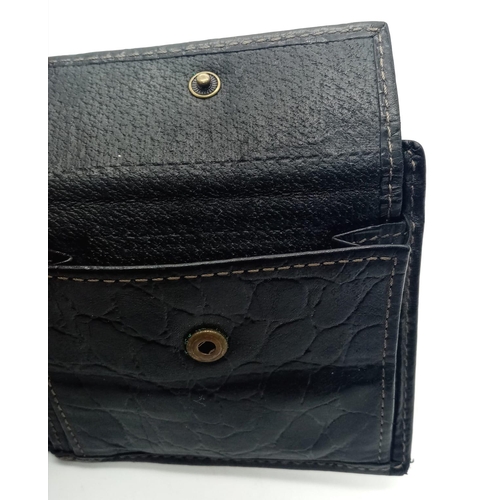 452 - A black leather Mulberry wallet, can hold up to 8 cards, includes a coin pouch. Size approx. 11x9cm.... 