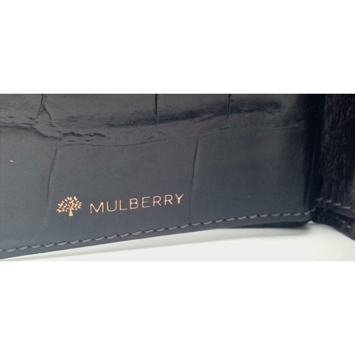 452 - A black leather Mulberry wallet, can hold up to 8 cards, includes a coin pouch. Size approx. 11x9cm.... 