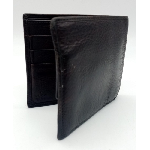 494 - A dark brown leather Gucci card wallet, 3 card holders with a popper pocket. Size approx. 11x9x2cm. ... 