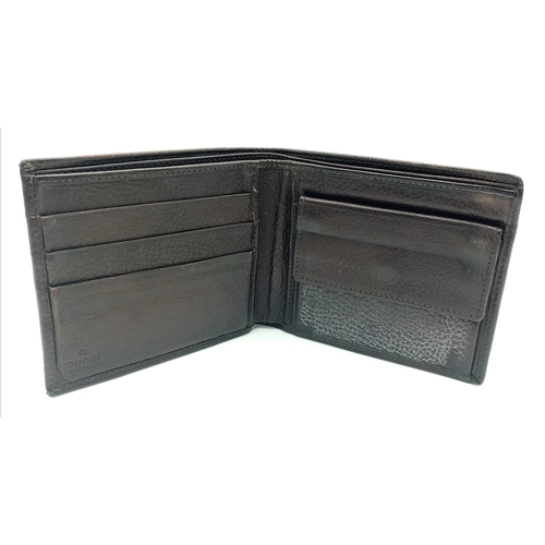 494 - A dark brown leather Gucci card wallet, 3 card holders with a popper pocket. Size approx. 11x9x2cm. ... 