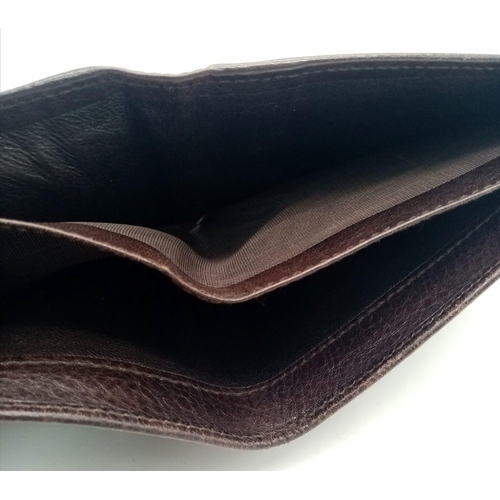 494 - A dark brown leather Gucci card wallet, 3 card holders with a popper pocket. Size approx. 11x9x2cm. ... 