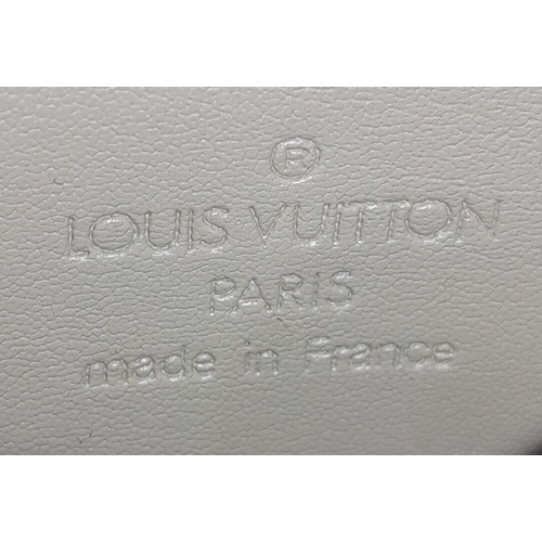 93 - A Louis Vuitton lime yellow Lexington pouch bag, patent leather exterior, beige interior, gold tone ... 