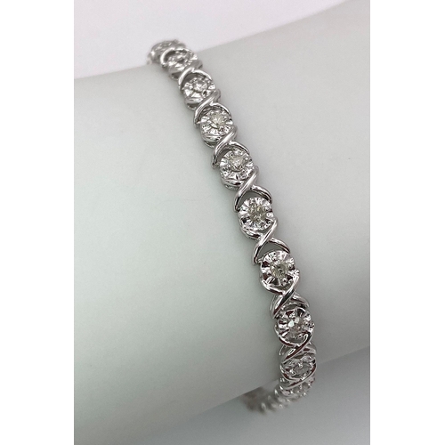 151 - A 9K White Gold Diamond Tennis Bracelet in a Criss-Cross Link Formation. 17cm length. 5.5g total wei... 