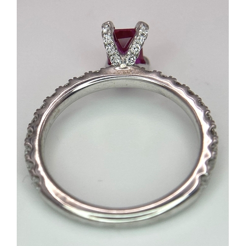 171 - A very elegant platinum ring with an emerald cut ruby and diamonds (0.60 carats) on the crown and th... 